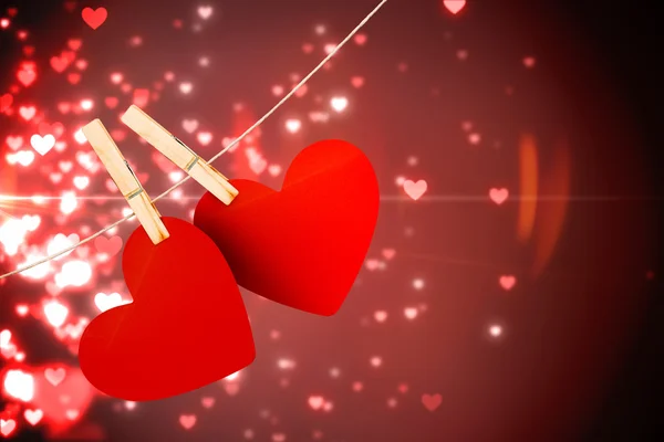 Composite image of hearts hanging on line — Stock Photo, Image