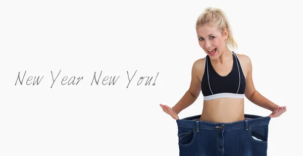 Thin woman wearing old pants after losing weight — Stock Photo, Image