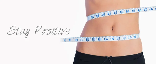 Fit belly surrounded by measuring tape — Stock Photo, Image