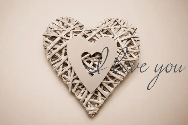 Composite image of wicker heart ornament with paper cut out — Stock Photo, Image