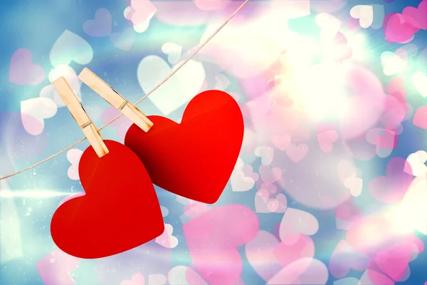 Composite image of hearts hanging on line — Stock Photo, Image