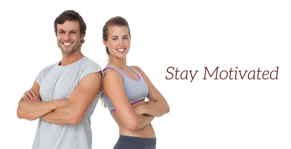 Portrait of a sporty young couple with arms crossed — Stock Photo, Image