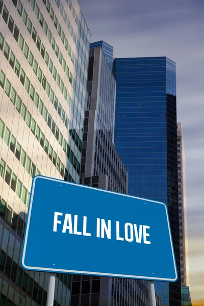 Fall in love against low angle view of skyscrapers — Stock Photo, Image