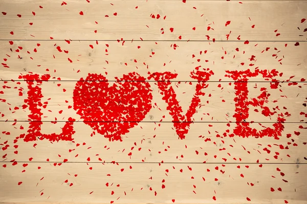 Composite image of love spelled out in petals — Stock Photo, Image