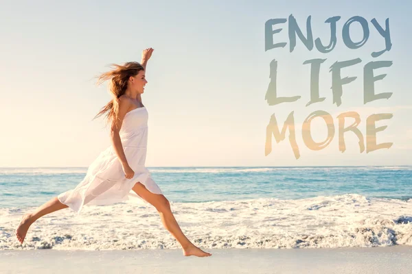 Beautiful blonde in white sundress jumping up — Stock Photo, Image