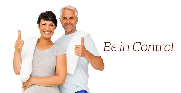 Portrait of a happy fit couple gesturing thumbs up — Stock Photo, Image