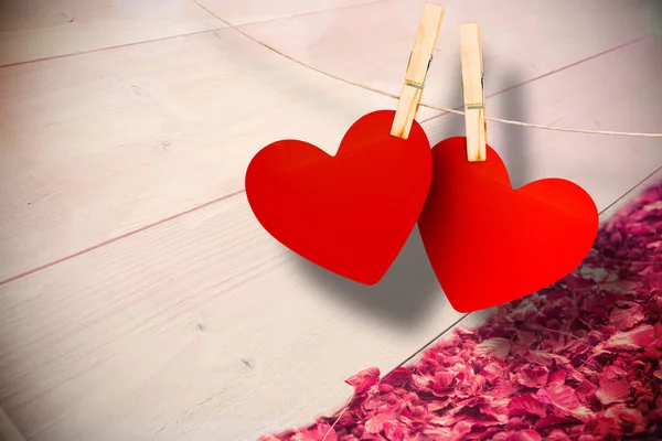 Composite image of hearts hanging on line — Stock Photo, Image