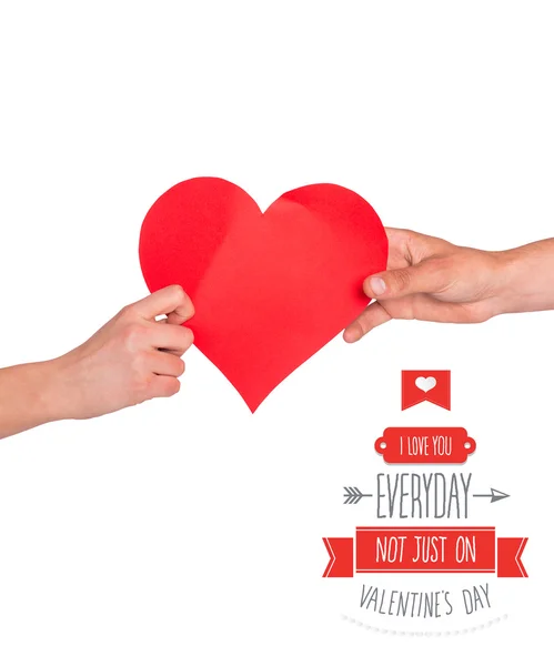 Composite image of hands holding red heart — Stock Photo, Image