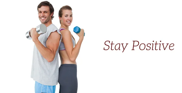 Portrait of a fit couple exercising with dumbbell — Stock Photo, Image