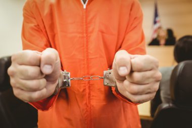 Prisoner in handcuffs clenching fists clipart