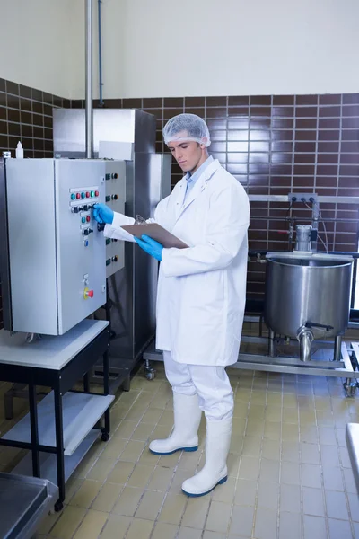 Focused biologist with safety gloves holding clipboard — Stock Photo, Image