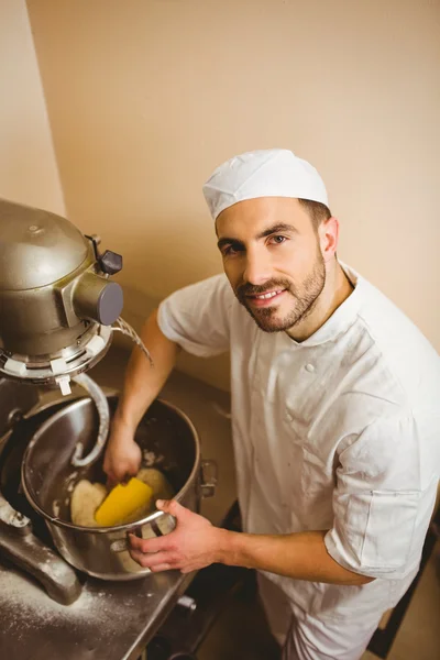 Baker using large mixer to mix dough — Stock Photo, Image
