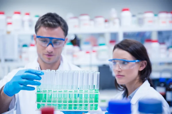 Chemist holding test tube tray — Stock Photo, Image