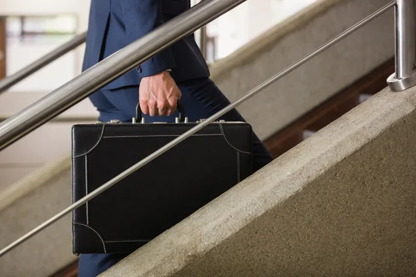 Businessman climbing up the stairs — Stock Photo, Image