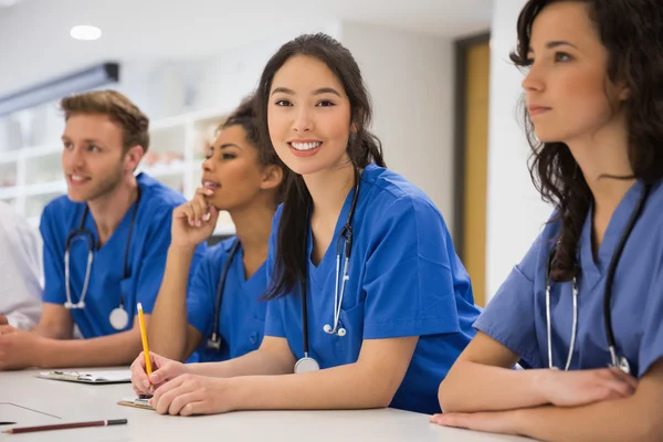 Medisch student glimlachen naar de camera tijdens de les — Stockfoto