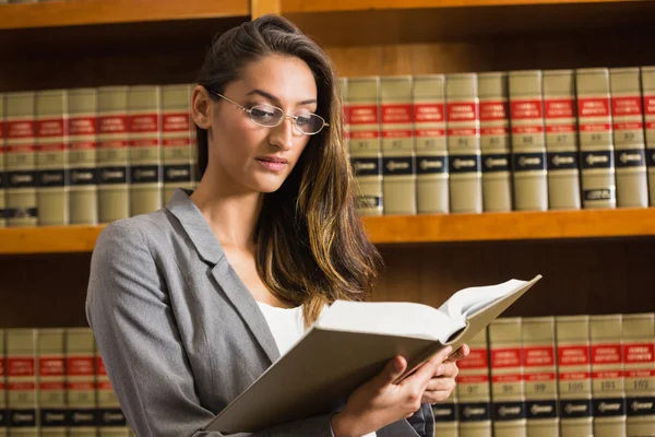 Pretty lawyer reading in the law library — Stock Photo, Image