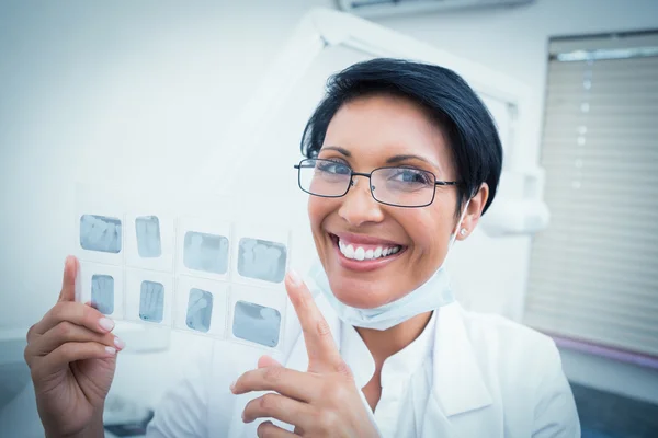 Happy female dentist holding x-ray — Stock Photo, Image