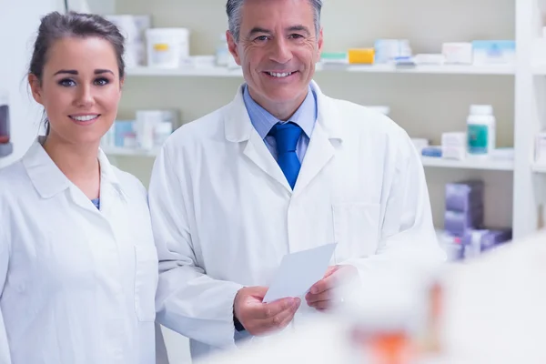 Pharmacist and his trainee looking at the camera — Stock Photo, Image