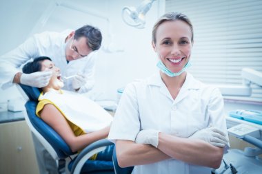 Male dentist with assistant clipart