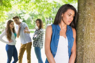 Lonely student being bullied by her peers clipart