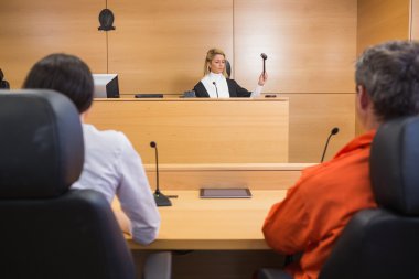 Lawyer and client listening to judge clipart