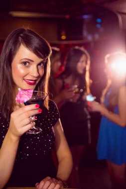 Pretty brunette drinking a cocktail clipart