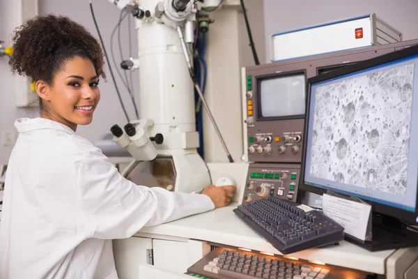 Estudiante de bioquímica usando microscopio grande — Foto de Stock