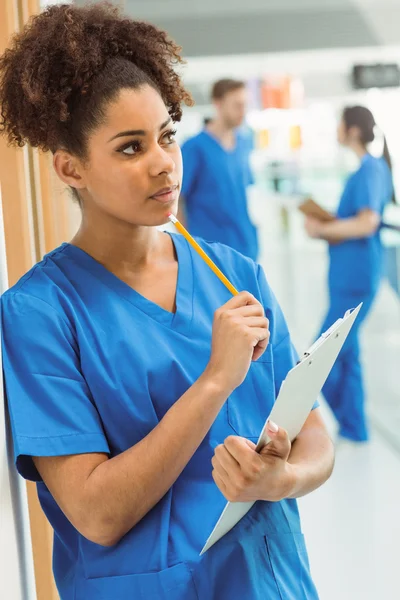 Medical student thinking in hallway — Stock Photo, Image