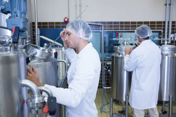 Scientists wearing lab coat and hair net — Stock Photo, Image