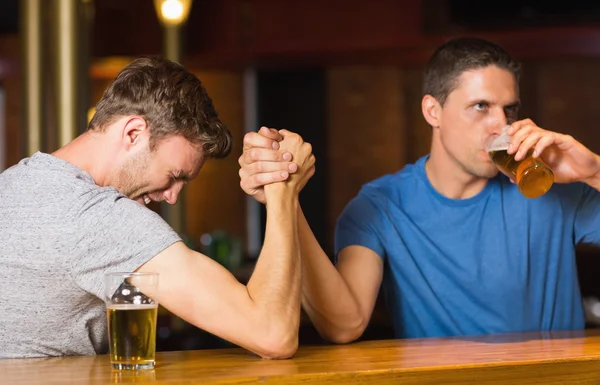Happy friend arm wrestling each other — Stock Photo, Image