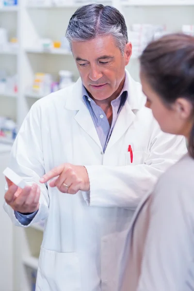 Pharmacist speaking with cheerful young customer — Stock Photo, Image