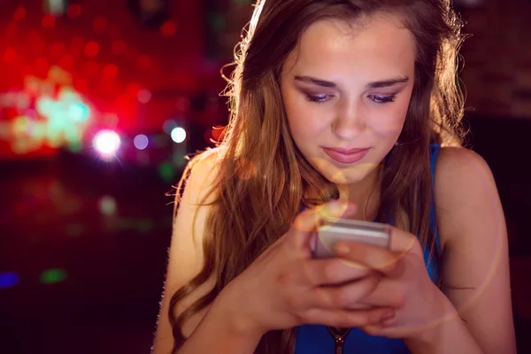 Menina bonita mensagens de texto em seu telefone — Fotografia de Stock