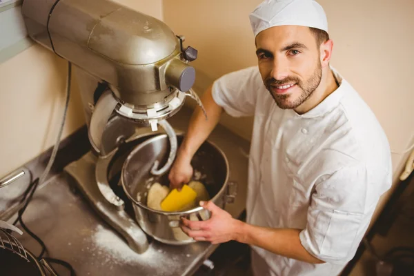 Baker using large mixer to mix dough — Stock Photo, Image