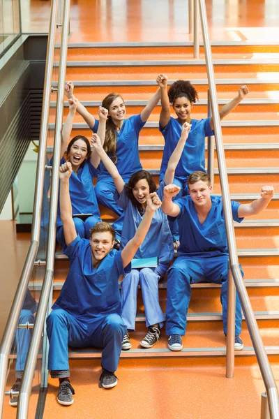 Medical students cheering on the steps — Stock Photo, Image
