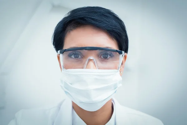 Dentista usando máscara cirúrgica e óculos de segurança — Fotografia de Stock