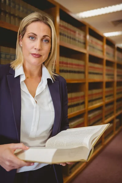 Serious librarian reading a book — Stock Photo, Image