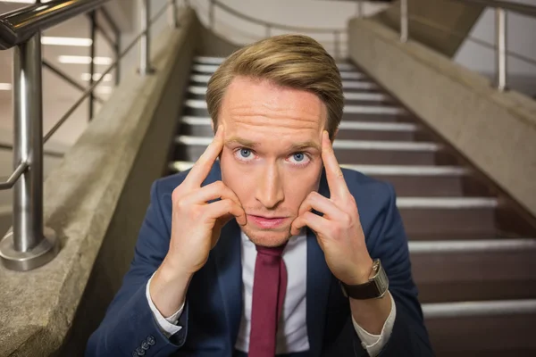 Stressed businessman sitting on steps — Stock Photo, Image