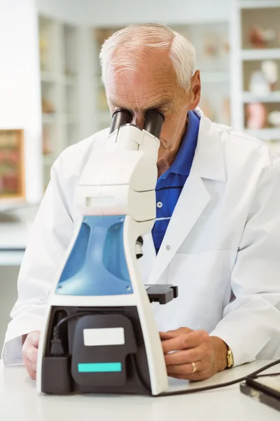 Senior scientist working with microscope — Stock Photo, Image