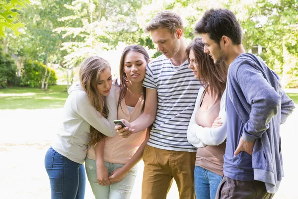 Šťastní studenti na koleji při pohledu na smartphone mimo — Stock fotografie