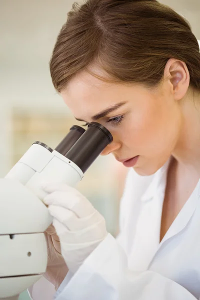 Joven científico que trabaja con microscopio — Foto de Stock