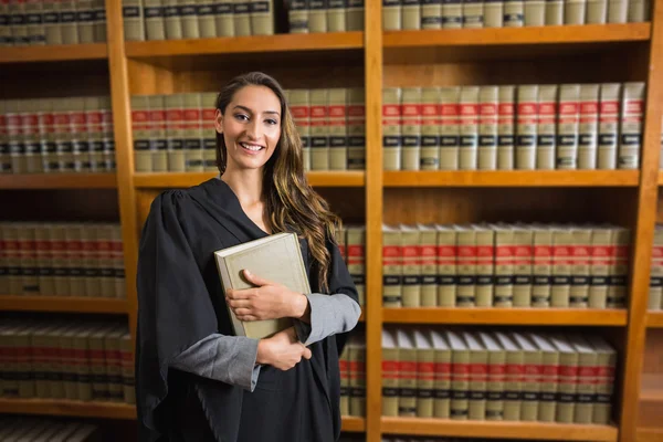 Pretty lawyer looking at camera in the law library — Stock Photo, Image