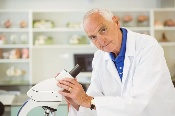 Senior scientist working with microscope — Stock Photo, Image