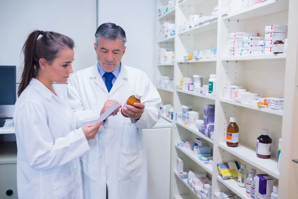 Farmacéutico y aprendiz hablando juntos — Foto de Stock