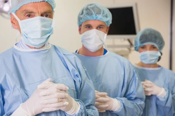 Medical student and lecturer looking at camera in scrubs — Stock Photo, Image