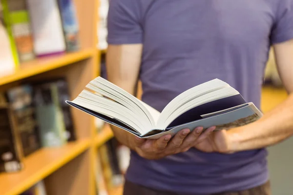 University student standing holding textbook — Stock Photo, Image