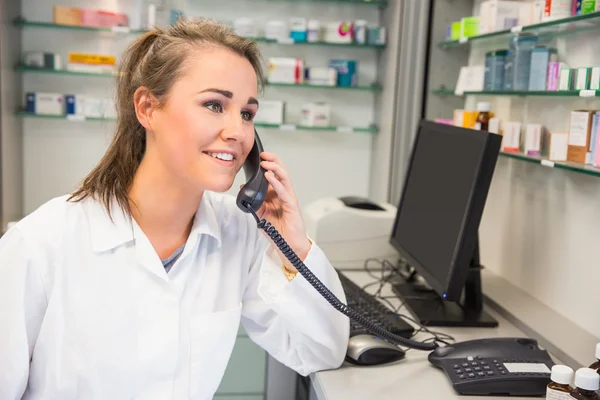 Young pharmacist on the phone — Stock Photo, Image