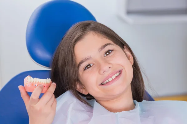 Portrait of a smiling young patient showing model — Stock Photo, Image