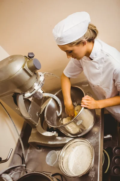 Baker using large mixer to mix dough — Stock Photo, Image