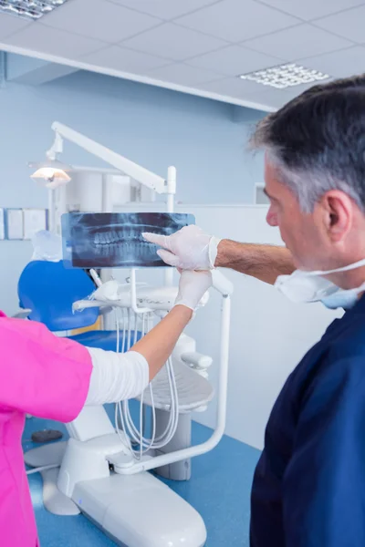 Dentist pointing something at x-ray — Stock Photo, Image