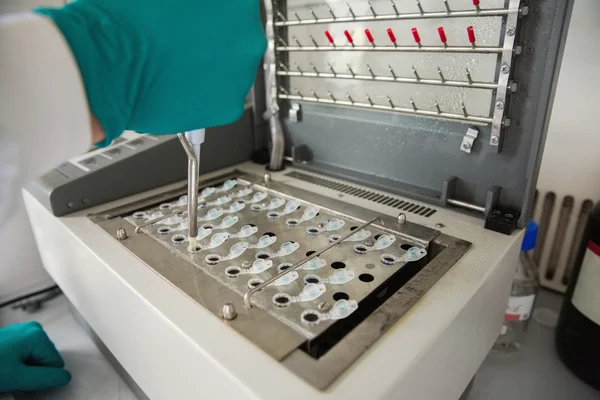 Young scientist using a pipette in chamber — Stock Photo, Image